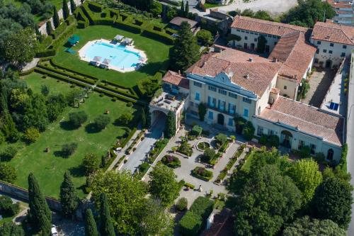 The estate from above — the pool, the clipped parterre and the rooftops