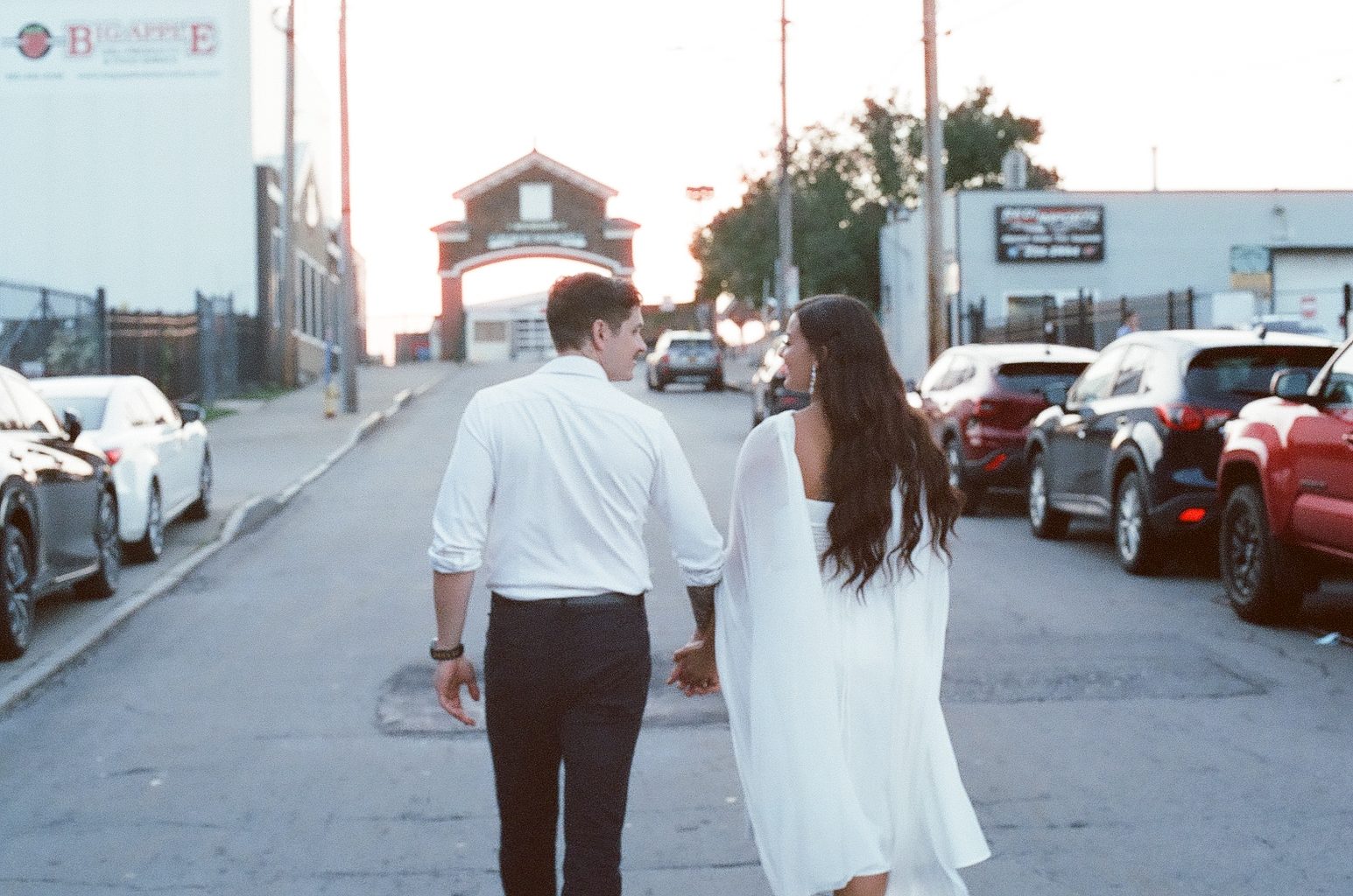 Alyssa and Giovanni walking hand in hand down Railroad Street