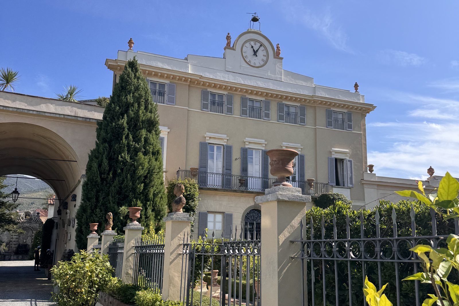 The walkway up to Villa Scorzi, the arch on one side and the clock tower above the façade